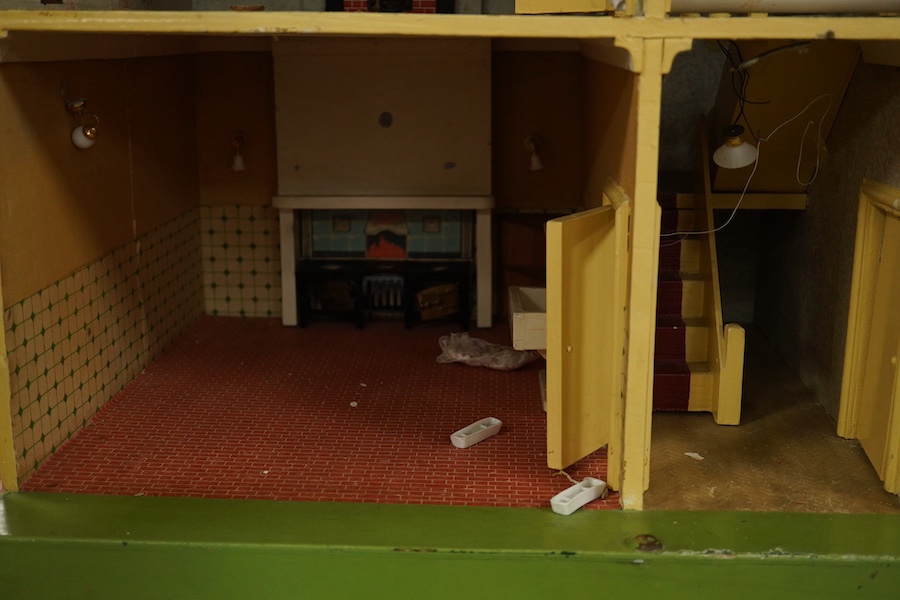 A modern ‘Vine House’ dolls house with furniture and accessories; a large six room house with hall and stairwell, the front wall opening in two sections on hinges each side, with internal decoration and lighting, width 1
